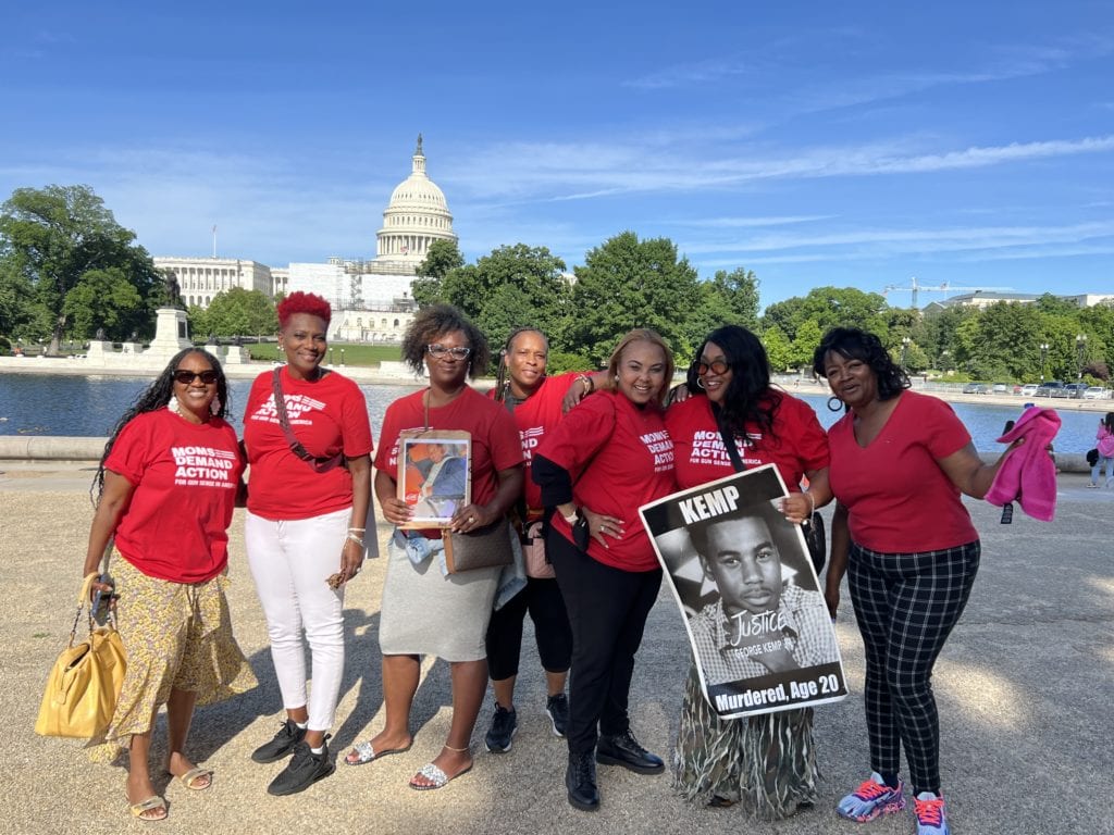 Melody stands with a group of six other Moms Demand Action volunteers at an event in Washington, D.C.