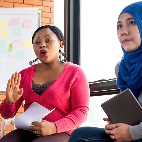 Multiethnic women in colorful casual clothes discussing in the group meeting