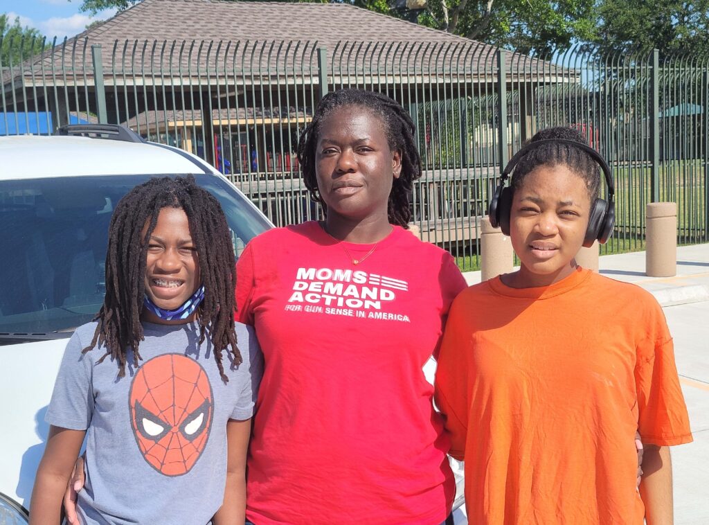 La’Shay Black poses for a photo next to her children
