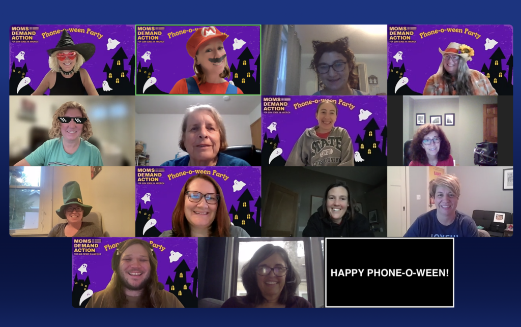 A screenshot of a "phone-o-ween" Zoom call. Many of the 15 attendees have purple Zoom backgrounds with "Moms Demand Action" and "Phone-o-Ween Party" in orange text.