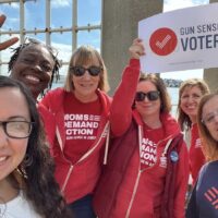 Six Moms Demand Action volunteers smile for a photo wearing Gun Sense Voter and/or Moms Demand Action t-shirts as they work to help elect Gun Sense Candidates.