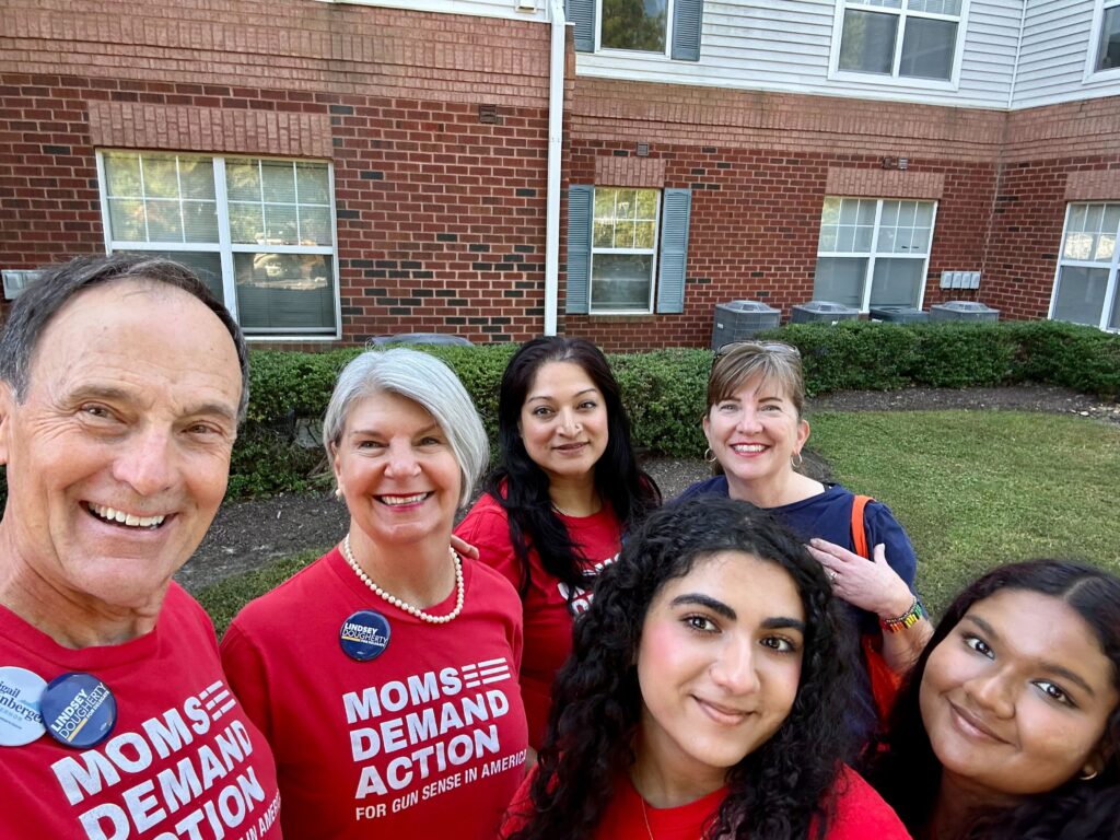 Four Moms Demand Action volunteers and two Students Demand Action volunteers take a selfie while canvassing for Gun Sense Candidates in Virginia.