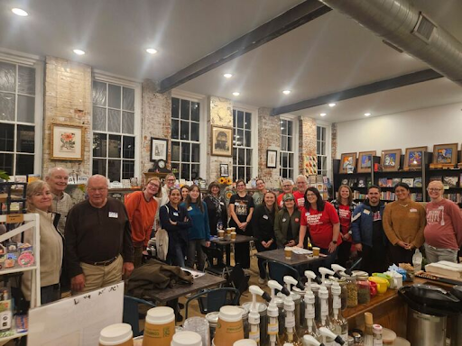 Over 30 people pose for a photo in a coffee shop in Northern Kentucky during a Moms Demand Action relaunch meeting.
