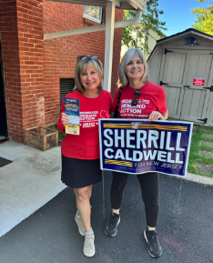Two Moms Demand Action volunteers pose for a photo during a New Jersey canvassing event. One volunteer holds a candidate brochure in her hand; the other holds a Sherrill/Caldwell sign.